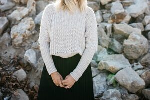 woman in gray sweater and black skirt