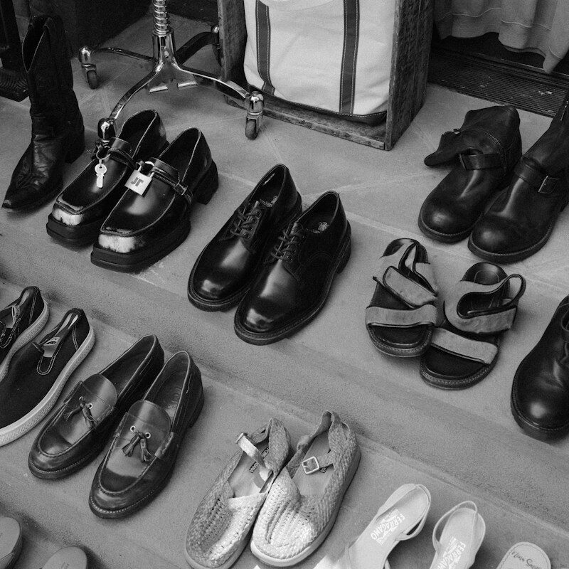 Various shoes and clothing items displayed on outdoor steps