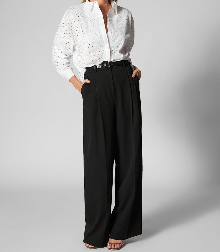 Woman in white shirt and black wide-leg pants