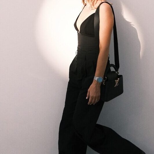 a woman standing in front of a white wall