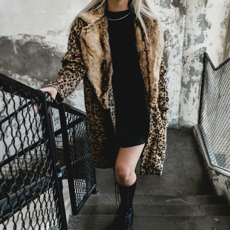 woman standing on gray stairs